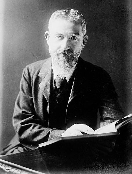 455px-George_Bernard_Shaw_at_desk_with_book